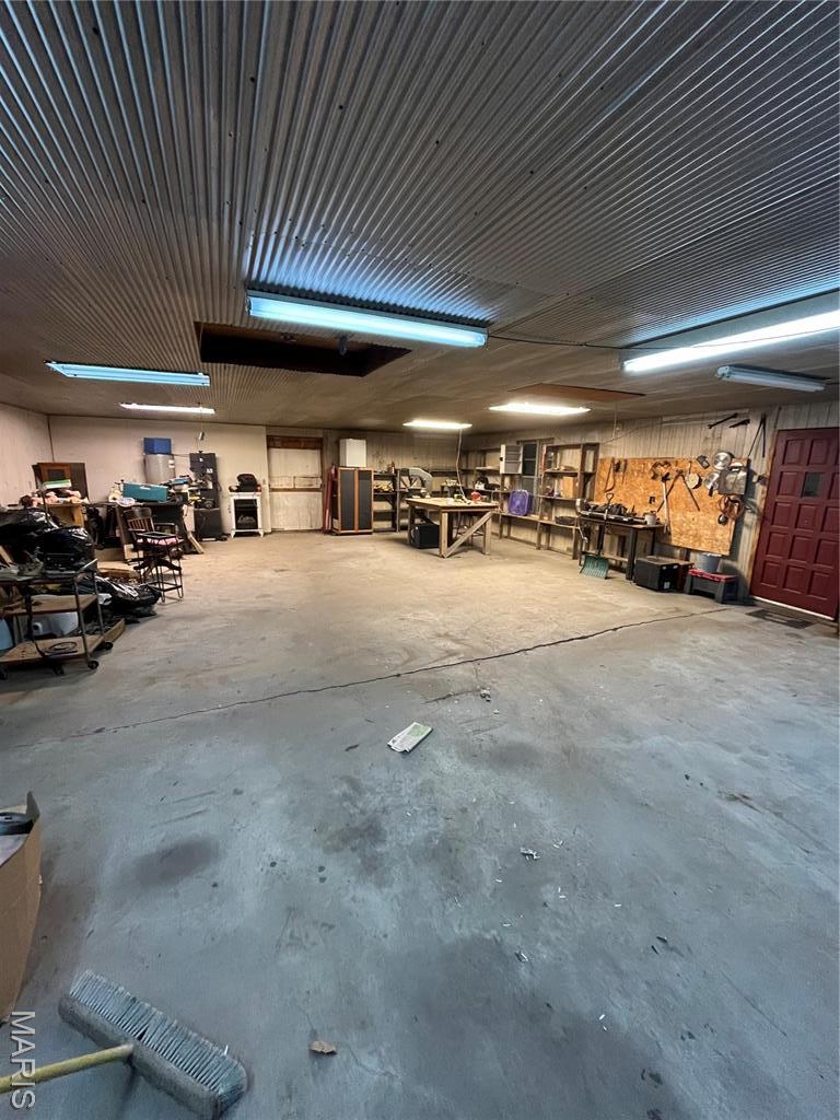 1004 W Taylor St, Bowling Green, MO 63334 - miscellaneous room featuring unfinished concrete flooring and a garage
