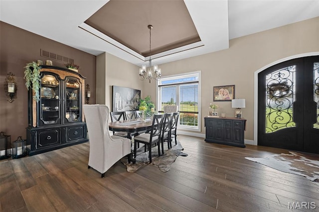 32 Taylors Way, Foristell, MO 63348 - dining room with a tray ceiling, a chandelier, dark wood-type flooring, and french doors