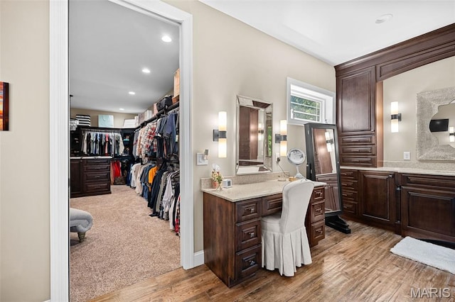 32 Taylors Way, Foristell, MO 63348 - bathroom featuring wood finished floors, a spacious closet, recessed lighting, and vanity