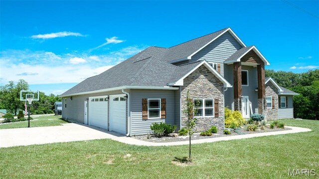 3215 Timber Ridge Rd, Palmyra, MO 63461 - view of front facade featuring stone siding, driveway, an attached garage, and a front lawn