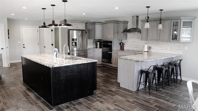 3215 Timber Ridge Rd, Palmyra, MO 63461 - kitchen featuring wall chimney range hood, appliances with stainless steel finishes, dark wood-type flooring, gray cabinets, and recessed lighting