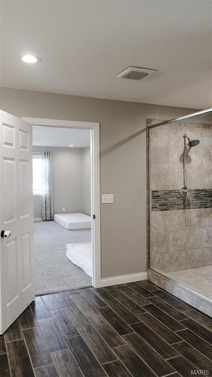 3215 Timber Ridge Rd, Palmyra, MO 63461 - bathroom featuring wood finish floors, a tile shower, and recessed lighting