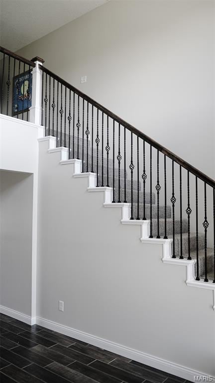 3215 Timber Ridge Rd, Palmyra, MO 63461 - staircase featuring wood tiled floors and a towering ceiling