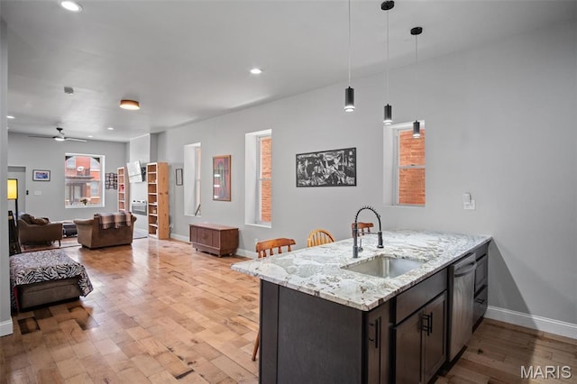 3452 Osage St, Saint Louis, MO 63118 - kitchen featuring dishwasher, light wood-style flooring, light stone counters, decorative light fixtures, and recessed lighting