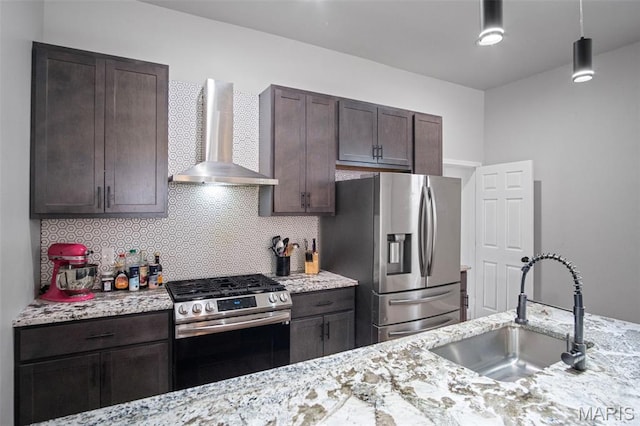 3452 Osage St, Saint Louis, MO 63118 - kitchen with wall chimney exhaust hood, stainless steel appliances, dark brown cabinets, and tasteful backsplash