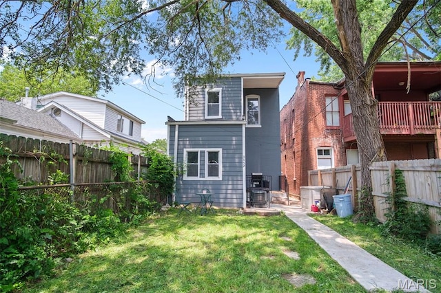 3452 Osage St, Saint Louis, MO 63118 - rear view of house featuring a fenced backyard