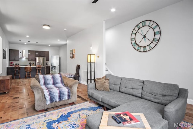3452 Osage St, Saint Louis, MO 63118 - living area with light wood finished floors, recessed lighting, and stairway