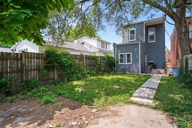 3452 Osage St, Saint Louis, MO 63118 - rear view of house with a fenced backyard