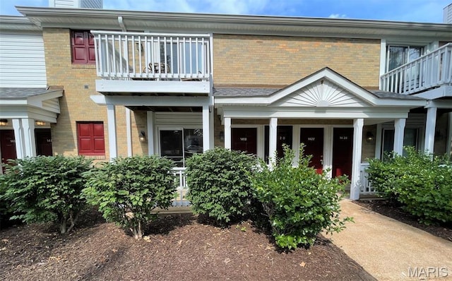 1418 Bluebird Ter, Saint Louis, MO 63144 - view of front of home with a balcony, brick siding, and a chimney