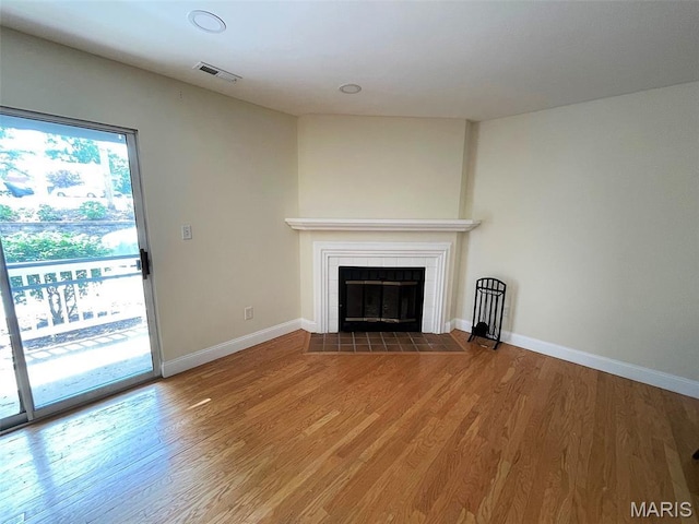 1418 Bluebird Ter, Saint Louis, MO 63144 - unfurnished living room featuring a fireplace and wood finished floors