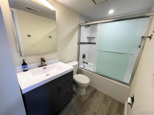 1418 Bluebird Ter, Saint Louis, MO 63144 - bathroom featuring wood finished floors, vanity, and bath / shower combo with glass door