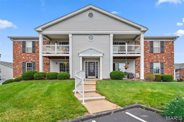 2 Berview Cir Unit H, Saint Louis, MO 63129 - view of front of house with a balcony, brick siding, and a front lawn