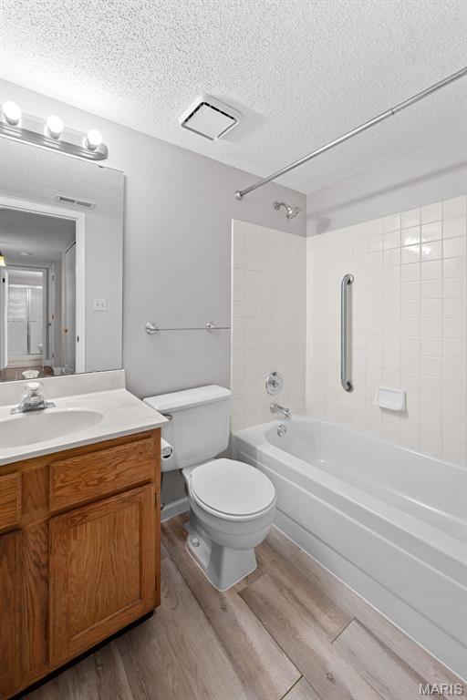 2 Berview Cir Unit H, Saint Louis, MO 63129 - full bath featuring wood finished floors, a textured ceiling, shower / washtub combination, and vanity