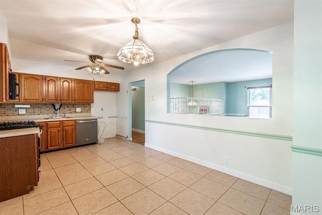 1907 Lone Pine Dr, Arnold, MO 63010 - kitchen with dishwasher, a chandelier, arched walkways, ceiling fan, and brown cabinetry