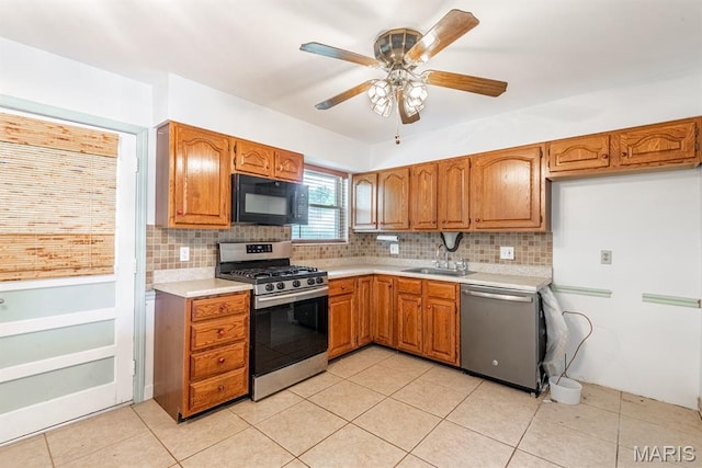 1907 Lone Pine Dr, Arnold, MO 63010 - kitchen featuring stainless steel appliances, light countertops, backsplash, and brown cabinetry