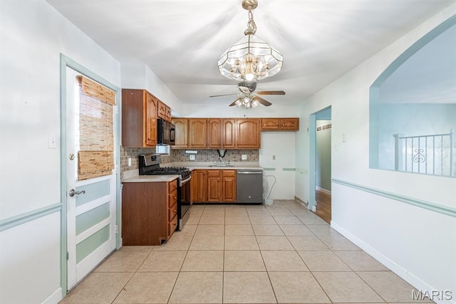 1907 Lone Pine Dr, Arnold, MO 63010 - kitchen featuring stainless steel appliances, ceiling fan, light countertops, backsplash, and brown cabinetry
