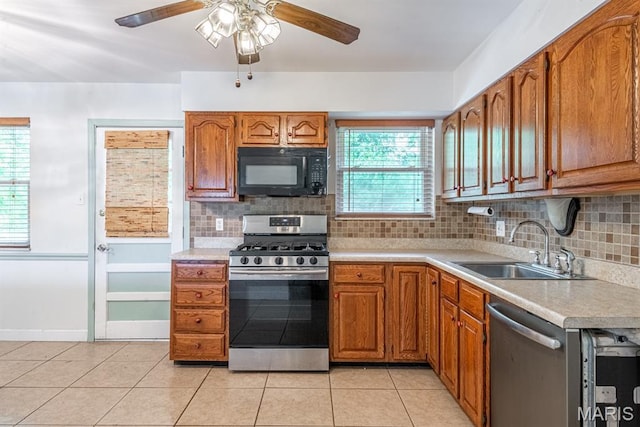 1907 Lone Pine Dr, Arnold, MO 63010 - kitchen with stainless steel appliances, light countertops, ceiling fan, and brown cabinetry