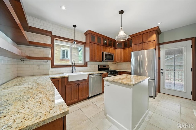 5743 Delor St, Saint Louis, MO 63109 - kitchen featuring stainless steel appliances, backsplash, hanging light fixtures, light stone counters, and recessed lighting