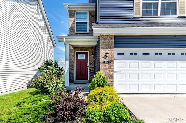 502 Summer Glen Ln, Saint Charles, MO 63301 - view of exterior entry featuring an attached garage and driveway