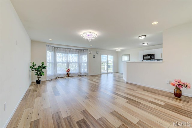 502 Summer Glen Ln, Saint Charles, MO 63301 - unfurnished living room with light wood-style flooring and recessed lighting