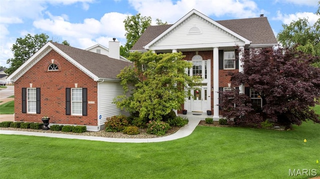 16368 Cherry Orchard Dr, Grover, MO 63040 - neoclassical home with brick siding, a front lawn, and a shingled roof