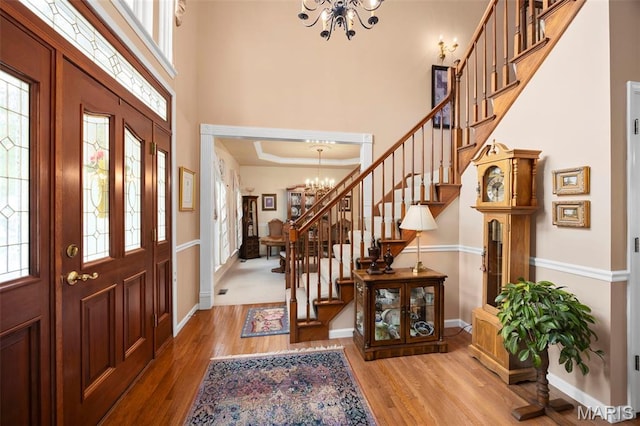 16368 Cherry Orchard Dr, Grover, MO 63040 - entryway featuring a chandelier, stairway, healthy amount of natural light, light wood-style flooring, and a high ceiling