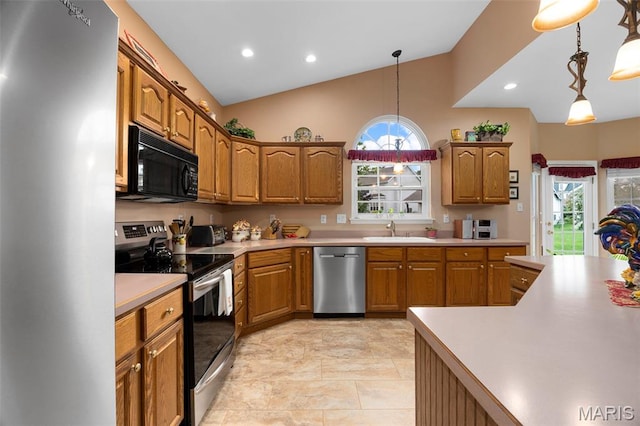 16368 Cherry Orchard Dr, Grover, MO 63040 - kitchen with appliances with stainless steel finishes, light countertops, brown cabinetry, decorative light fixtures, and recessed lighting