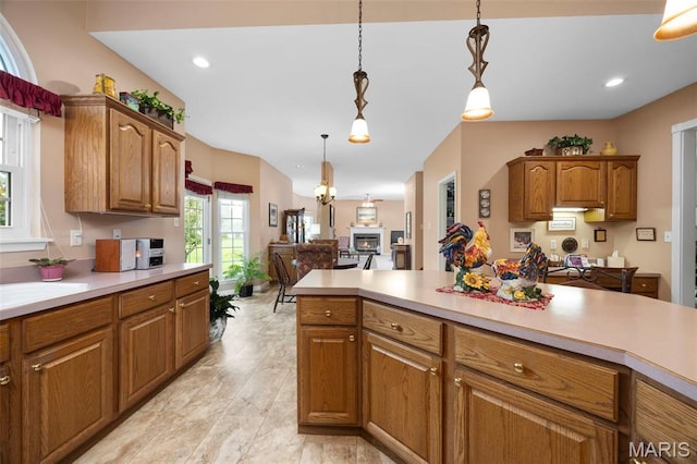 16368 Cherry Orchard Dr, Grover, MO 63040 - kitchen featuring light countertops, decorative light fixtures, brown cabinets, and recessed lighting