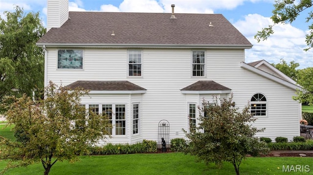 16368 Cherry Orchard Dr, Grover, MO 63040 - rear view of property featuring a shingled roof, a yard, and a chimney