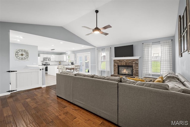 2607 Riley Paul Ct, Ofallon, MO 63368 - living room featuring ceiling fan, dark wood-style flooring, vaulted ceiling, and a brick fireplace
