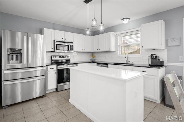 2607 Riley Paul Ct, Ofallon, MO 63368 - kitchen with stainless steel appliances, tasteful backsplash, light tile patterned flooring, and a center island