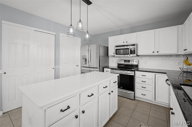 2607 Riley Paul Ct, Ofallon, MO 63368 - kitchen featuring stainless steel appliances, light tile patterned floors, white cabinets, decorative light fixtures, and a kitchen island