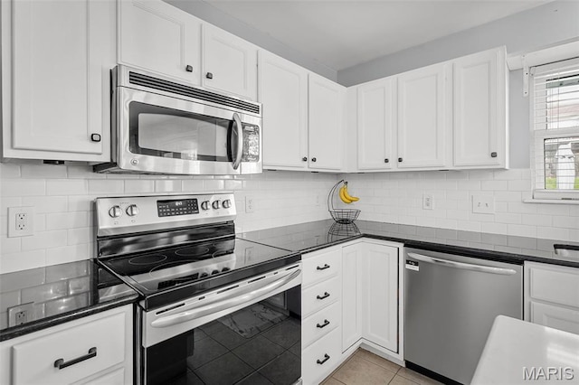 2607 Riley Paul Ct, Ofallon, MO 63368 - kitchen with stainless steel appliances, dark countertops, white cabinetry, and tasteful backsplash