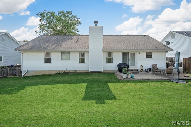 2607 Riley Paul Ct, Ofallon, MO 63368 - rear view of property featuring a fenced backyard, a patio area, a chimney, entry steps, and roof with shingles