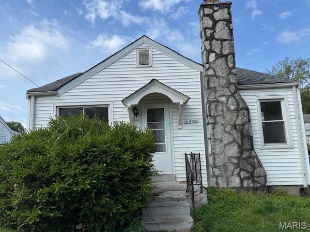 7446 Calvin Ave, Country Club Hills, MO 63136 - view of front facade with roof with shingles and a chimney