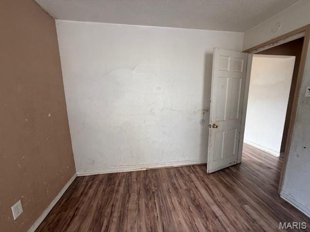 7446 Calvin Ave, Country Club Hills, MO 63136 - empty room featuring wood finished floors and a textured ceiling
