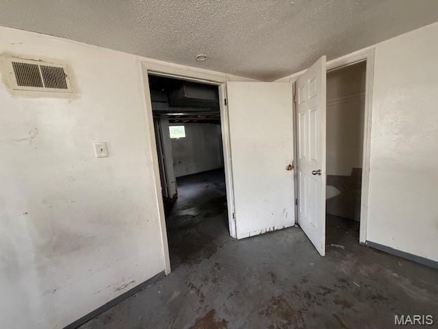 7446 Calvin Ave, Country Club Hills, MO 63136 - unfurnished bedroom featuring unfinished concrete flooring and a textured ceiling