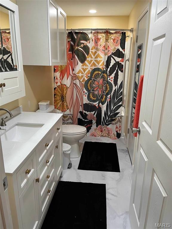 746 State Highway P, New Madrid, MO 63869 - bathroom featuring marble look tiles, vanity, and recessed lighting