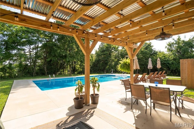 16533 Chateau Ln, Dexter, MO 63841 - swimming pool featuring view of wooded area, a patio area, outdoor dining space, and a pergola