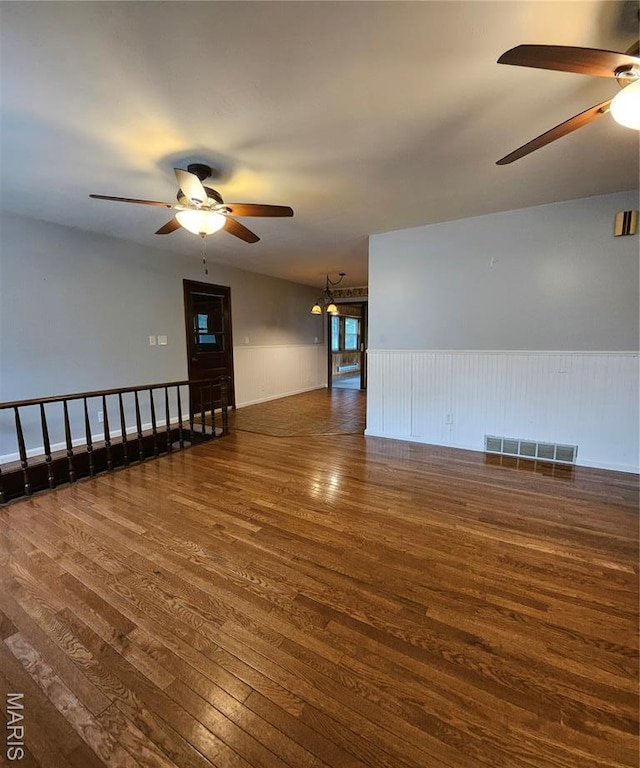 1504 Dean Ave, Hannibal, MO 63401 - empty room featuring a ceiling fan, wood finished floors, and wainscoting