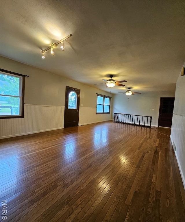 1504 Dean Ave, Hannibal, MO 63401 - unfurnished room featuring dark wood-type flooring, wainscoting, ceiling fan, and track lighting