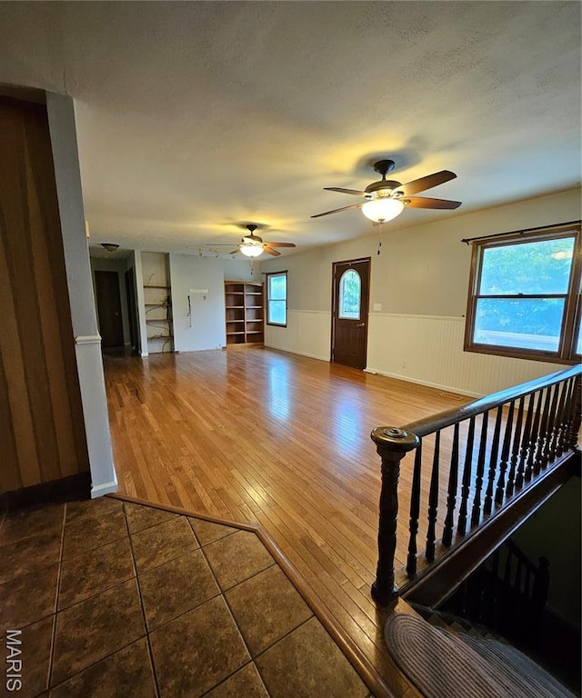 1504 Dean Ave, Hannibal, MO 63401 - unfurnished living room featuring wainscoting, a ceiling fan, and tile patterned floors