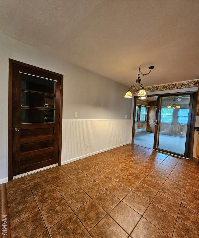 1504 Dean Ave, Hannibal, MO 63401 - unfurnished room with wainscoting, tile patterned floors, and a chandelier
