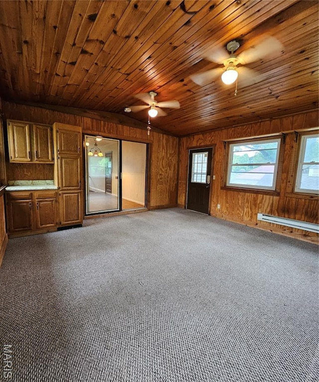 1504 Dean Ave, Hannibal, MO 63401 - carpeted spare room featuring wooden walls, healthy amount of natural light, a ceiling fan, wooden ceiling, and a baseboard heating unit