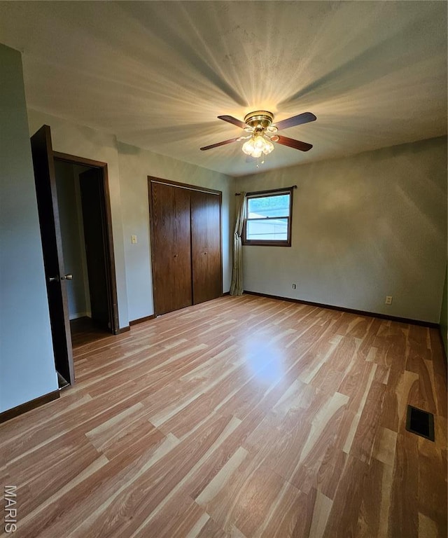 1504 Dean Ave, Hannibal, MO 63401 - unfurnished bedroom with light wood finished floors, a ceiling fan, and a closet
