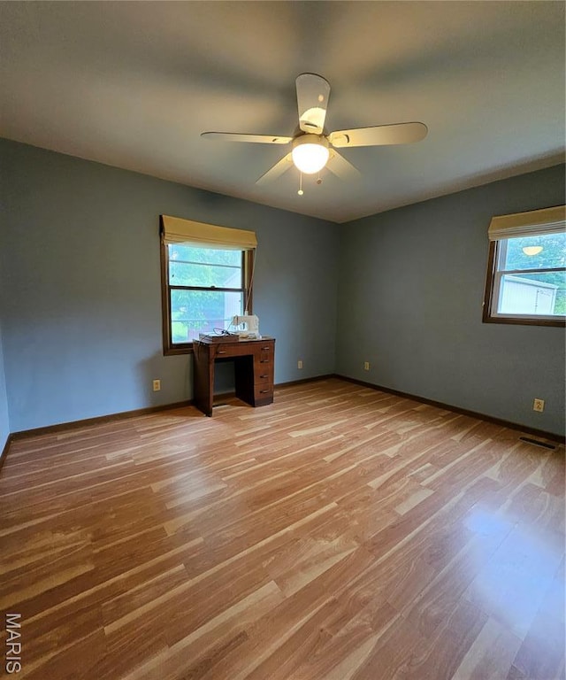 1504 Dean Ave, Hannibal, MO 63401 - empty room featuring plenty of natural light, light wood finished floors, and ceiling fan