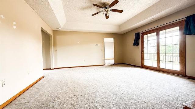 200 April Dr, Saint Robert, MO 65584 - carpeted empty room with ceiling fan, a textured ceiling, and a tray ceiling