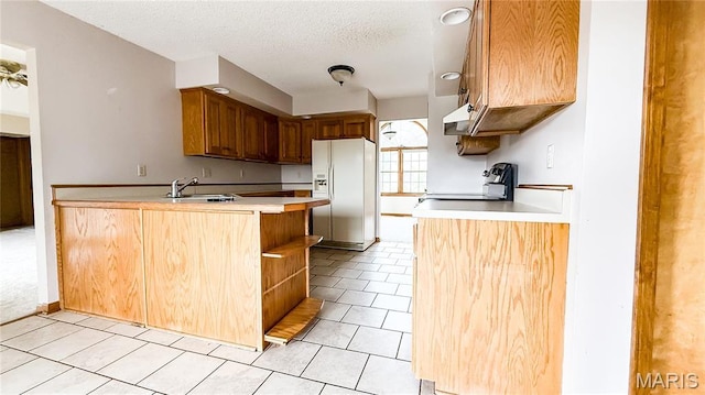 200 April Dr, Saint Robert, MO 65584 - kitchen featuring white fridge with ice dispenser, stove, a peninsula, light countertops, and light tile patterned floors