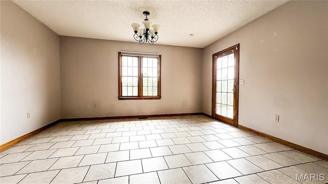 200 April Dr, Saint Robert, MO 65584 - empty room with plenty of natural light, a textured ceiling, and a chandelier