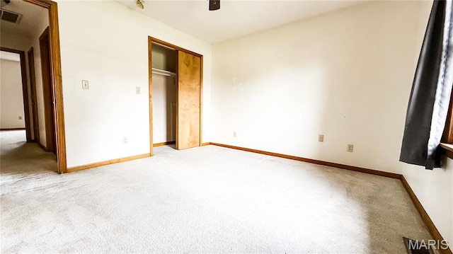 200 April Dr, Saint Robert, MO 65584 - unfurnished bedroom featuring light colored carpet, a closet, and a ceiling fan